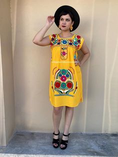 "Mexican boho festival mini dress. made of cotton with bright floral hand embroidery. Perfect for summer, spring, mexican parties, music festivals, etc. Fits size Small Measurements taken flat: Armpit to armpit 19 1/2\" Bottom hem width 25\" Shoulder to bottom hem 37 1/2\"" Folk Style Sleeveless Embroidered Festival Dress, Sleeveless Folk Embroidered Dress With Floral Embroidery, Folk Style Sleeveless Dress With Multicolor Embroidery, Traditional Sleeveless Embroidered Fiesta Dress, Traditional Sleeveless Embroidered Dress For Fiesta, Folk Style Sleeveless Embroidered Summer Dress, Sleeveless Floral Embroidered Dress For Fiesta, Multicolor Embroidered Dress For Cinco De Mayo, Summer Embroidered Dress For Fiesta