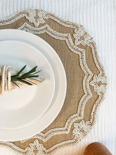 a place setting with white plates and napkins