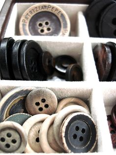 an assortment of buttons in a box