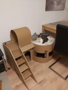 a cardboard cat house made to look like a boat