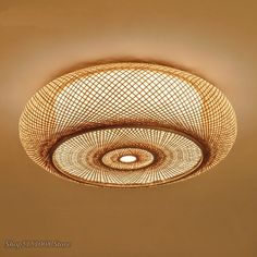 a ceiling light that is hanging from the ceiling in a room with beige walls and flooring