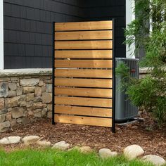 an air conditioner sitting next to a wooden fence