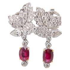 Presenting an enchanting creation from Rewa Jewelry, these ruby and diamond earrings seamlessly blend classic inspiration with contemporary elegance—a true masterpiece that reflects the brand's commitment to exceptional craftsmanship and timeless allure. Inspired by classic design elements, these earrings feature a captivating pair of rubies at the center, totaling 2.02 carats. Certified by Gem Research Swisslab (GRS), these rubies showcase the highly coveted 'Pigeon Blood' Red color, sourced from the revered Burmese mines. Notably, these gemstones are entirely natural and devoid of heat treatment, ensuring their exceptional purity. The GRS certificate numbers, GRS-2022-110463 and GRS-2022-110442, stand as a testament to the authenticity and superior quality of these remarkable rubies. Sur Ruby And Diamond Earrings, Blood Red Color, Diamond Earring, Blood Red, No Heat, Ruby Diamond, Burmese, Design Element, Paloma