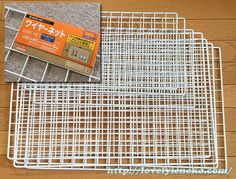 two pieces of wire mesh sitting on top of a wooden floor next to each other