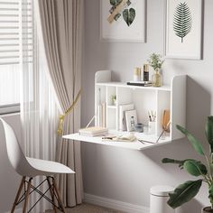 a white desk and chair in a room with pictures on the wall above it, next to a potted plant