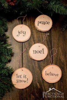 some wood slices with words on them hanging from a christmas tree branch that says, you can write festive words