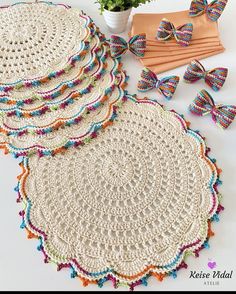 several crocheted doily are arranged on a table