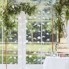 a table with a cake and some white birds on it