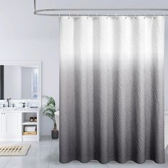 a bathroom with a shower curtain that has an ombrella pattern on the side