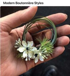 a person is holding some flowers in their hand with the caption modern boutonniere styles