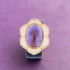 Discover the timeless elegance of our Estate Jewelry Collection with this exquisite vintage bracelet from the 1980s. Crafted from luxurious gold, this piece showcases a magnificent oval cabochon amethyst weighing approximately 87.00 carats, radiantly framed by 64 sparkling round diamonds totaling about 11.90 carats. This stunning bracelet combines classic glamour with sophisticated craftsmanship, making it a perfect heirloom piece that adds a touch of vintage charm to any ensemble. Pictured with Hermes Jige, Classic Glamour, Vintage Bracelet, The 1980s, Vintage Bracelets, Jewelry Vintage, Oval Cabochon, Anemone, Estate Jewelry