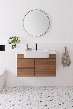 a bathroom with a sink, mirror and bathtub