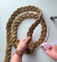 someone is crocheting a rope with scissors