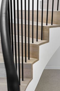 an image of a staircase with black handrails