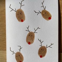 four reindeer's on white paper with red noses