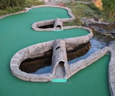 an artificial miniature golf course with water running through it