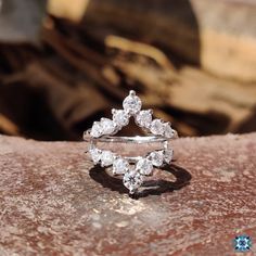 a diamond ring sitting on top of a rock