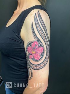 Polynesian with Hibiscus flower arm tattoo.