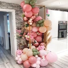 the balloon column is decorated with pink, green and white balloons