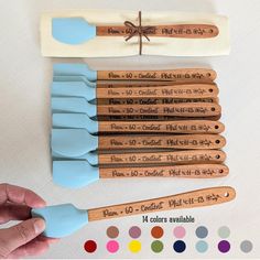 wooden utensils with writing on them sitting next to color swatches and markers