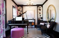 a living room filled with furniture and a piano