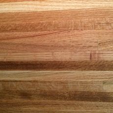 a close up view of the wood grains on a cutting board that is being used as a table top