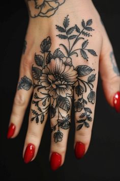 A hand with a detailed floral tattoo and red painted nails against a black background. Finger Tattoo Designs For Women, Finger Tattoo Ideas, Unique Butterfly Tattoos, Ink Therapy, Roman Numeral Tattoos, Small Heart Tattoos, Finger Tattoo Designs, Simple Geometric Pattern, Cartoon Character Tattoos