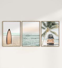 three surfboards are hanging on the wall next to each other in front of a beach scene