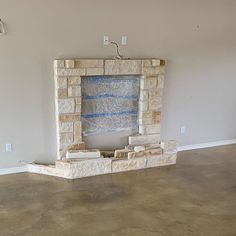 an empty room with a brick fireplace in the middle