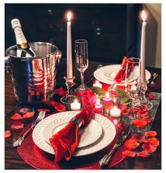 the table is set with candles, plates and silverware for an elegant valentine's day dinner