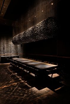 a long table and benches in a dark room