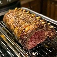 a large piece of meat cooking on top of an oven rack in the middle of it