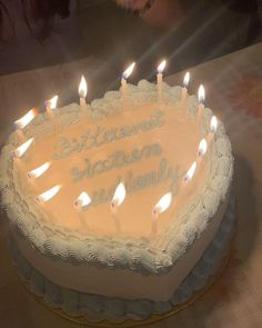 a birthday cake with lit candles on it