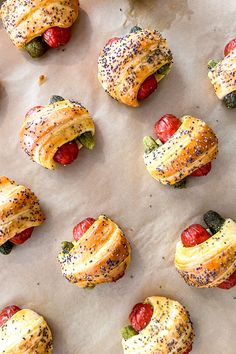 small pastries are lined up on a baking sheet