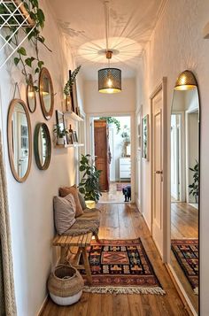 a hallway with mirrors and plants on the wall