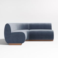 a blue couch sitting on top of a white floor