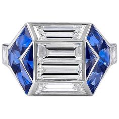 a blue and white diamond ring with three baguetts on the side, set in 18k white gold