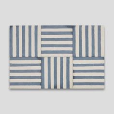 a blue and white striped tile with four different stripes on the tiles, all in various sizes