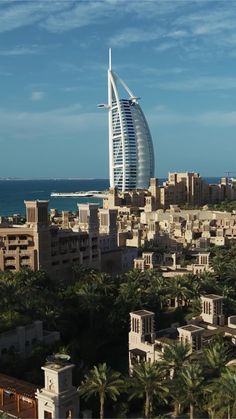 an aerial view of the burj al arab city with palm trees in front