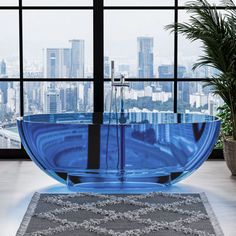 a blue bath tub sitting in front of a large window