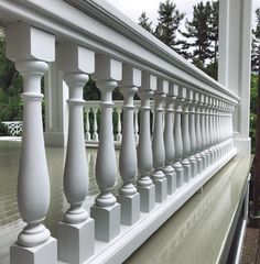 a white balcony railing with columns and balconies