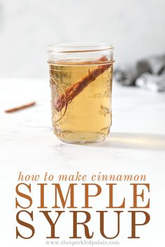 a glass jar filled with liquid sitting on top of a table next to cinnamon sticks