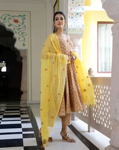 This is a 3-piece set. It comes with soft cotton hand block print anarkali kurta with 32 kali & gota detailing, round neck, sleeveless & ankle length.The set also comes with handblock print pants with semi elasticated waistband and kota doria dupatta with gota patti detailing. Color-Yellow & Honey Kurta Fabric-Voil Cotton Bottom Fabric-Voil Cotton Dupatta Fabric-Kota Doria Work-Block Print & Gota Patta Detailing Neck-V Neck Sleeves-3/4th Sleeves Washing Care-Dry Clean Only Block Print Anarkali, Printed Anarkali Suits, Anarkali Kurta Set, Mens Wear Wedding, Reception Look, Anarkali Kurta, Cotton Dupatta, Anarkali Suit, Cotton Bottoms