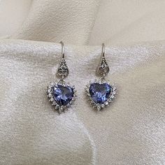 This gorgeous Sterling Silver cubic zirconia studded Tanzanite heart necklace and earring set would make the perfect classy gift for a bridesmaid, as an anniversary gift, for Valentine's Day or for Mother's Day. Tanzanite is the birthstone for those born in December, making it a thoughtful birthday gift as well! Pictures were taken both indoor and outdoors to best represent color. ~Measurements~ The heart pendant measures 1" tall and 3/4" wide. The Tanzanite heart stone is 12mm x 12mm. The match Born In December, Well Pictures, Tanzanite Jewelry, Jewelry Heart, Heart Stone, Jewelry Bridal, Necklace And Earring Set, Hair Accessories Jewelry, December Birthstone