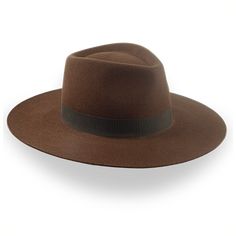 Description Materials Craftsmanship Hat Care Shipping Returns Product Description A Brown Wide Brim Rancher Fedora Discover the Caravan, a brown wide brim rancher fedora handcrafted from durable rabbit fur felt. Featuring a 5 1/4" center-dent crown and a 3 5/8" raw-edge flat brim, this hat offers both rugged style and all-day comfort. The smooth finish, genuine leather sweatband, and 1 1/4" grosgrain ribbon hatband provide a luxurious touch. Custom-made to fit your exact head size, the Caravan i Outdoor Hut, The Caravan, Homburg, Wide Brim Fedora, Hat Box, Custom Monogram, Hat Band, Brim Hat, Fedora Hat