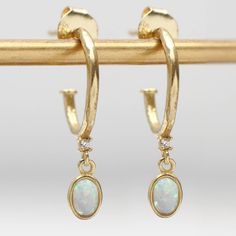 PRODUCT DESCRIPTION * Stunning semi precious crystal and opal, 18ct gold vermeil textured half hoop earrings. * They are a half hoop design and the butterfly back keeps them secure. * We regret we are unable to exchange earrings for hygiene reasons GIFT PACKAGING * These earrings come in a free Hurleyburley pouch, or you can pay £2 for a gift box. We can add a gift card for your special message. FREE STANDARD UK DELIVERY * Our standard postage is by Royal Mail 1st class post which has delivery guidelines of 1-2 working days but is not guaranteed to arrive within this timeframe. * This item is available for Express Next Day Delivery if ordered before 3pm MON - FRI MADE FROM * 18ct gold vermeil * Semi precious crystal * Semi precious opal * Hypo allergenic DIMENSIONS * 1.9cm x1.2cm PRODUCT C Half Hoop Earrings, Unique Opal, Precious Opal, Stylish Earrings, Hoop Design, Earring Cards, Stylish Earring, Vermeil Jewelry, Oval Stone