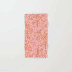 an orange and pink floral print napkin on a white surface