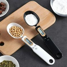 measuring spoons filled with food on top of a cutting board