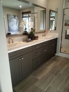 a large bathroom with two sinks and mirrors