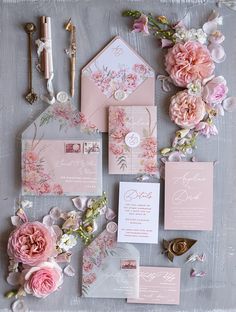 the wedding stationery is laid out with pink flowers and greenery, including peonies